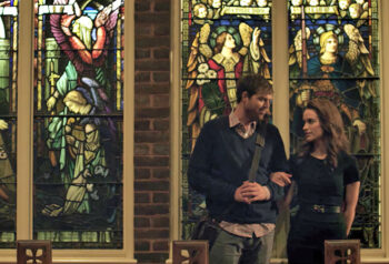 Melanie Scrofano and Dylan Taylor with stained glass - A Sunday Kind of Love